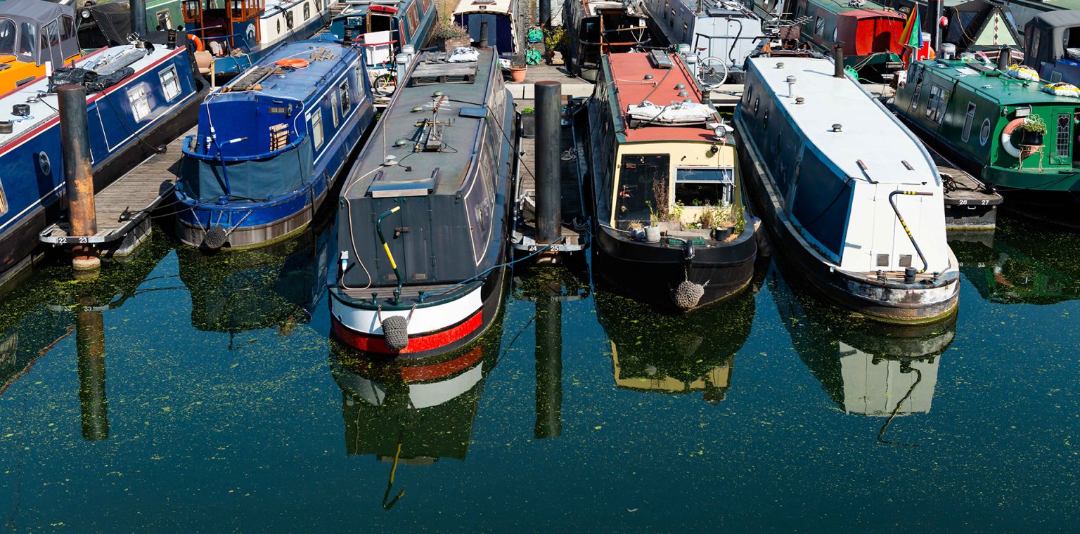 Narrow boats in a marina on the tidal Thames Narrow boats in a marina on the tidal Thames