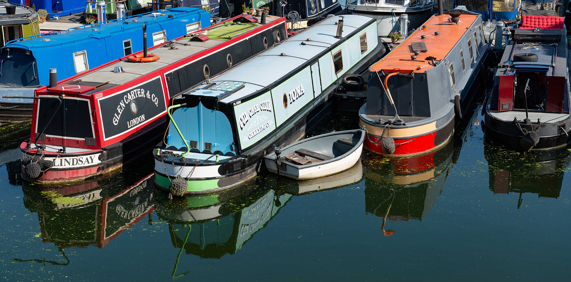 Narrow boats in a marina on the tidal Thames